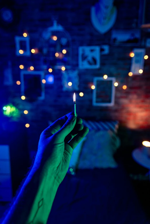 a person holding a lit match in their hand