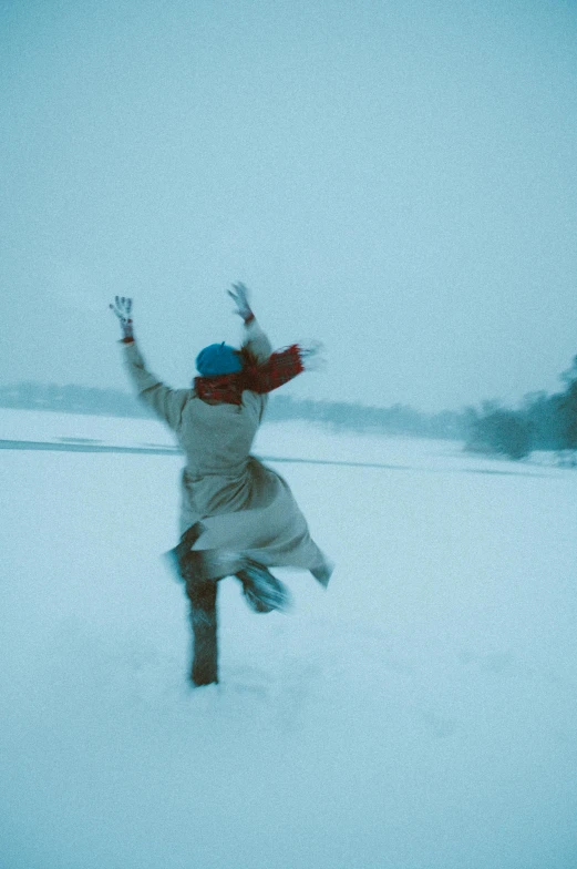 the man is running across the snow - covered ground