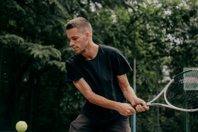 a man that has a tennis racket in hand