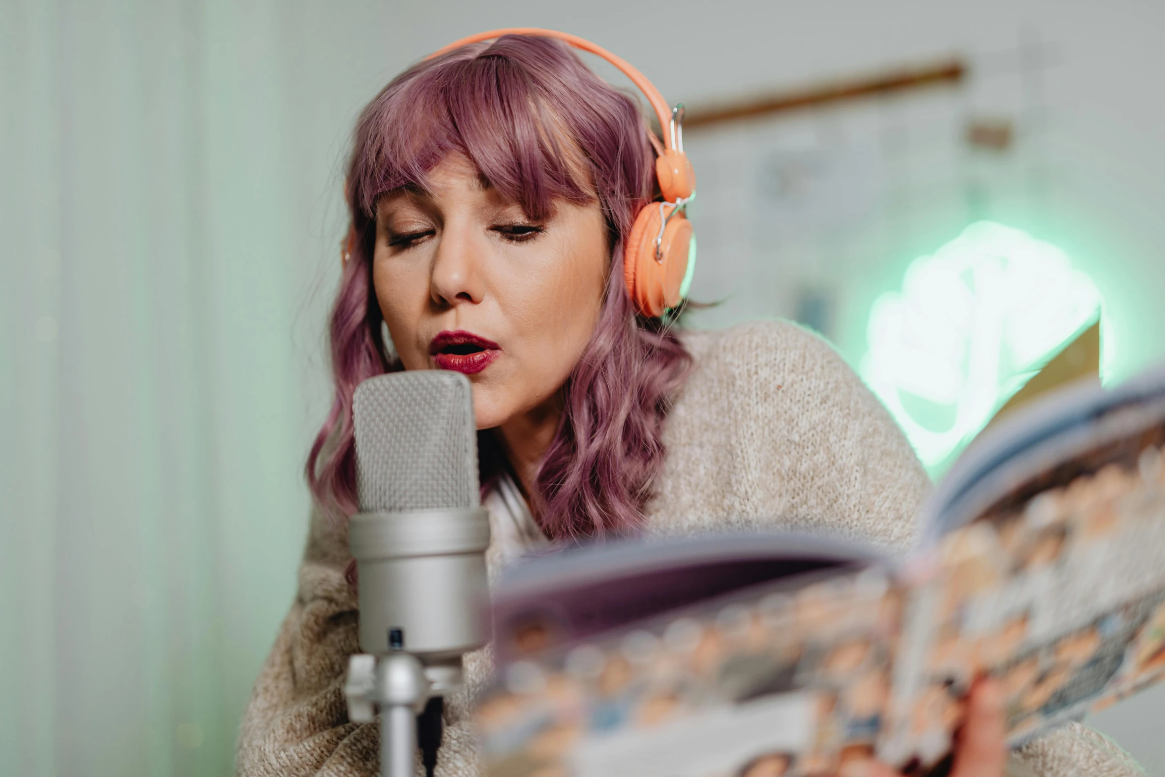 a woman with headphones on reading a newspaper