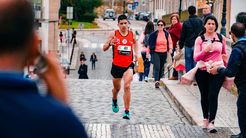 the man is running down the cobblestone path