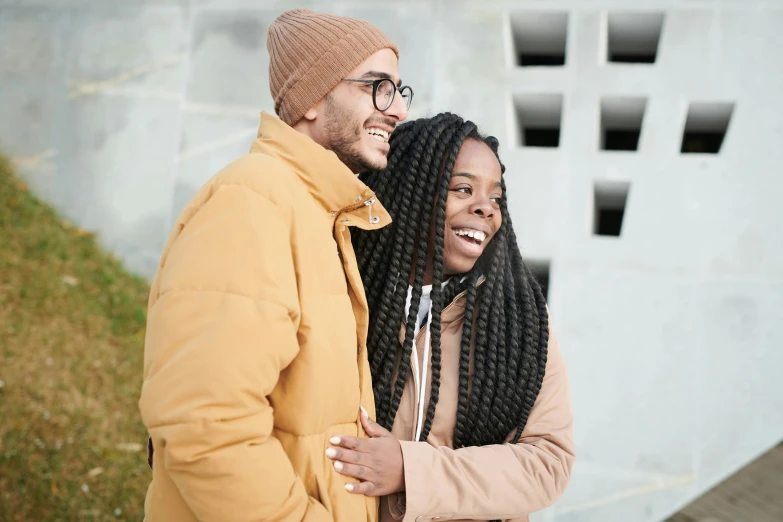 two men posing together in front of an urban area