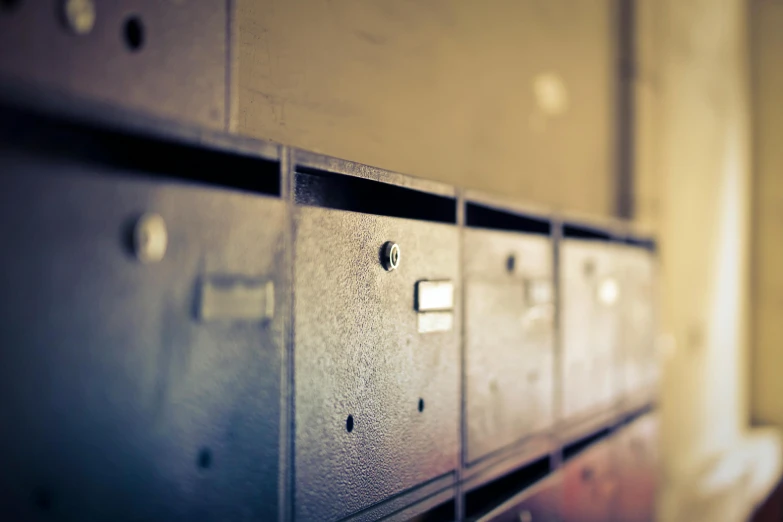 a row of metallic lockers with metal latches