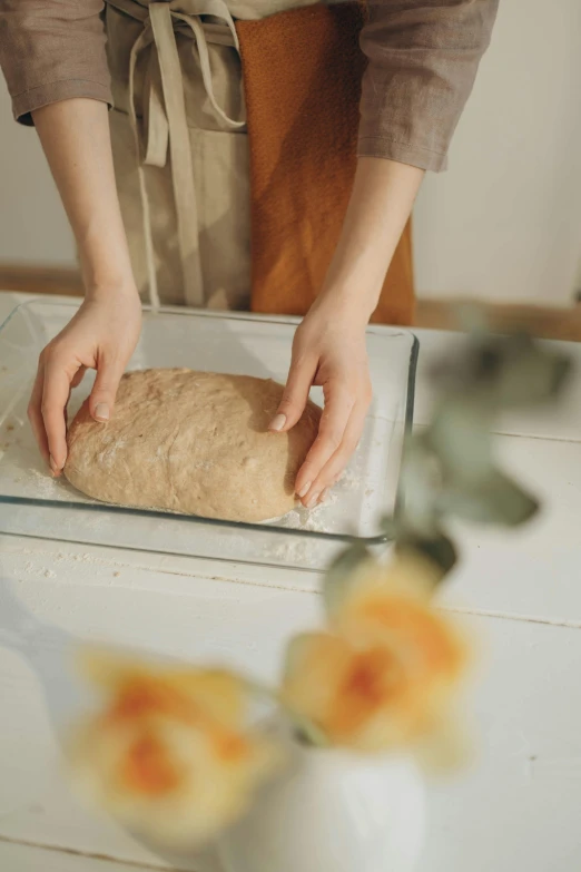 someone making bread with their hands on top of it