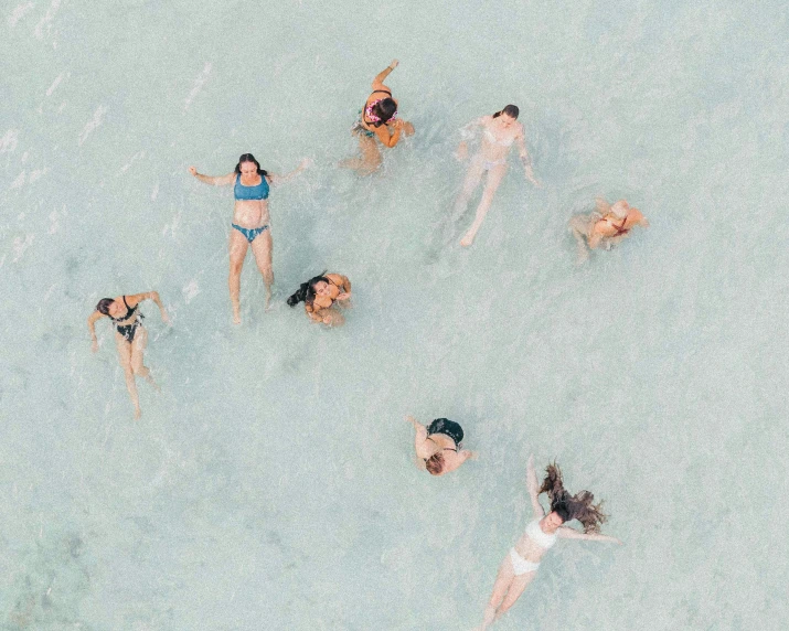 women enjoy the water while floating and enjoying some sunbathing
