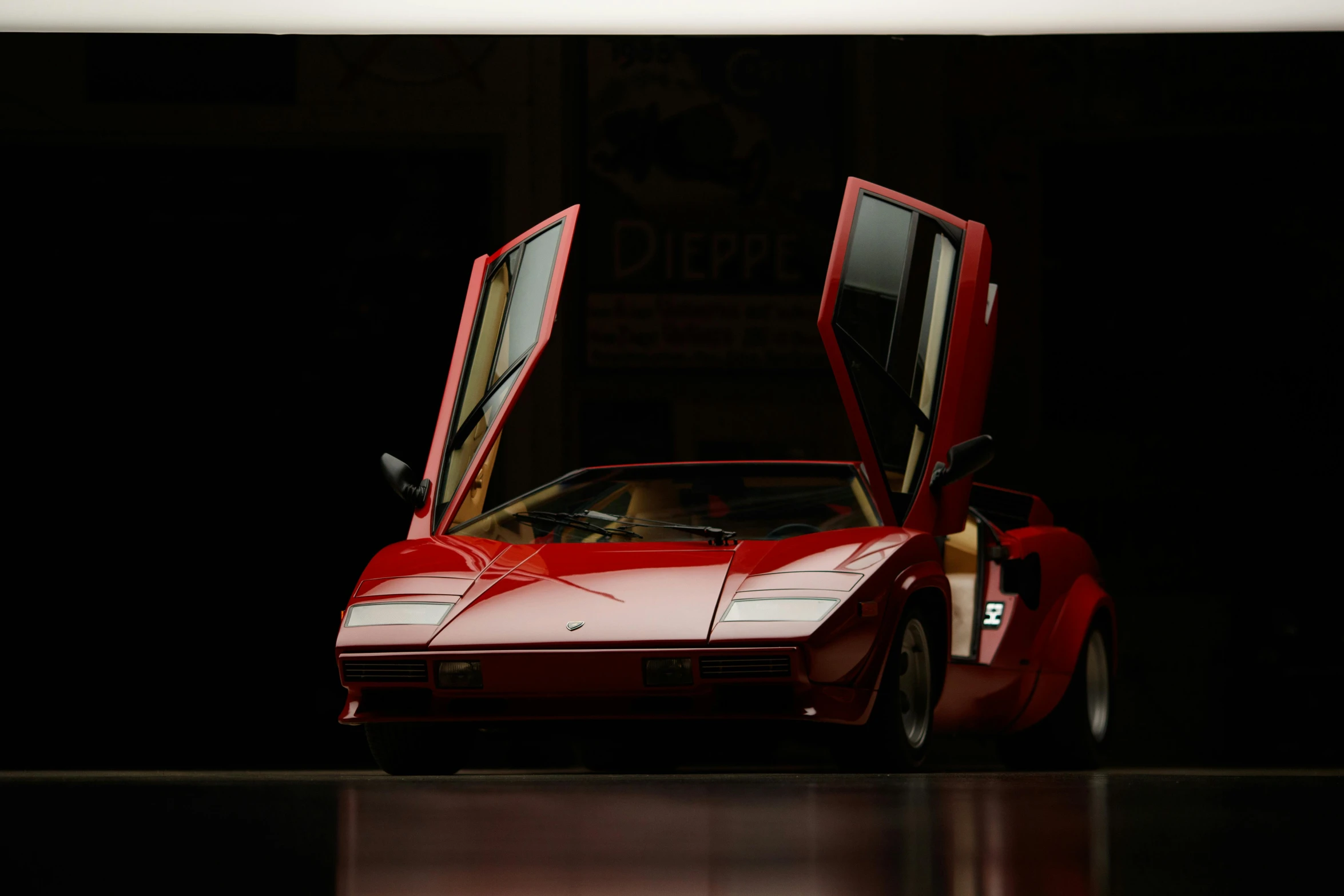 a very old red sports car sitting on top of a table