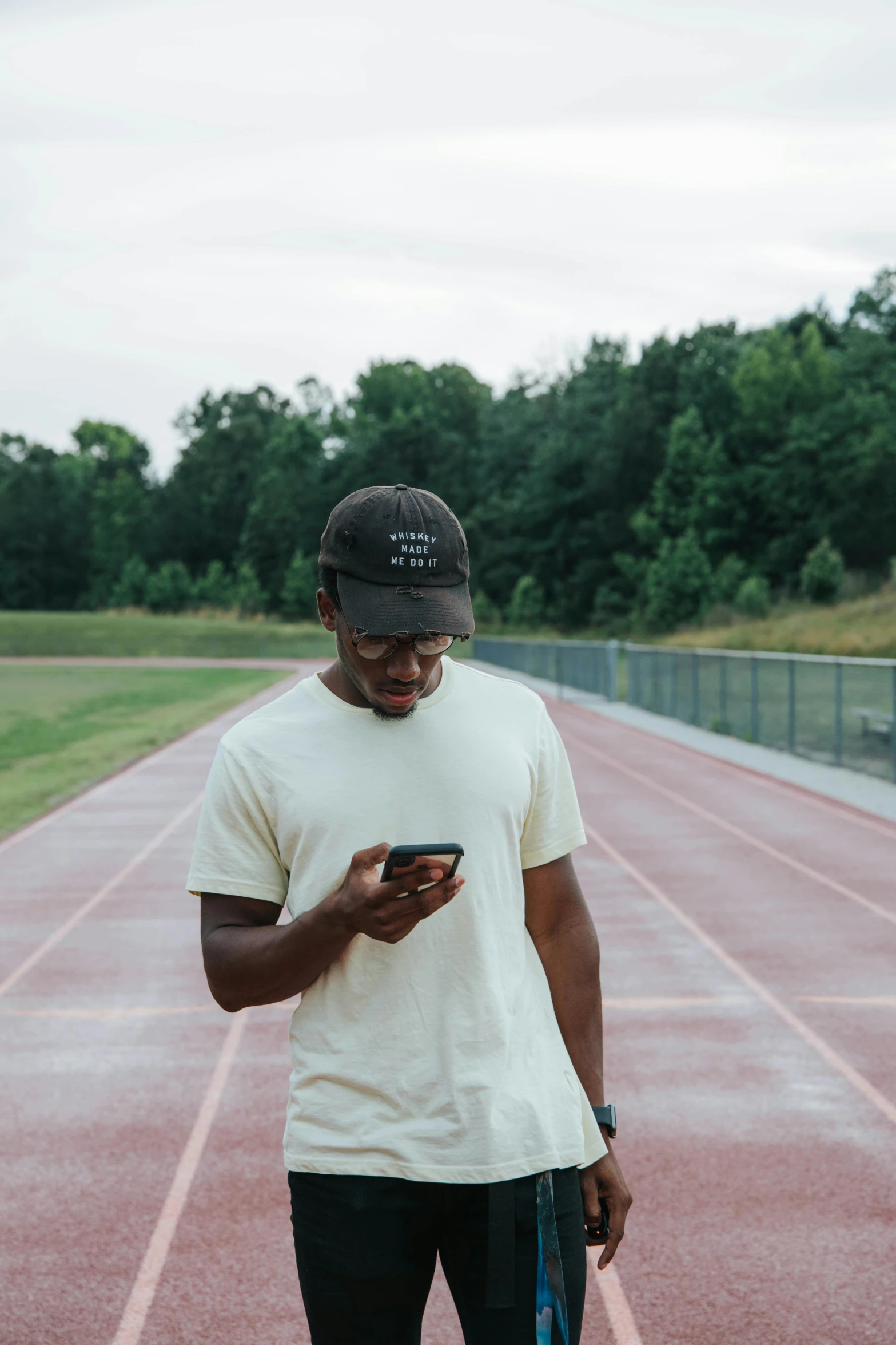 a person standing on a track holding a phone