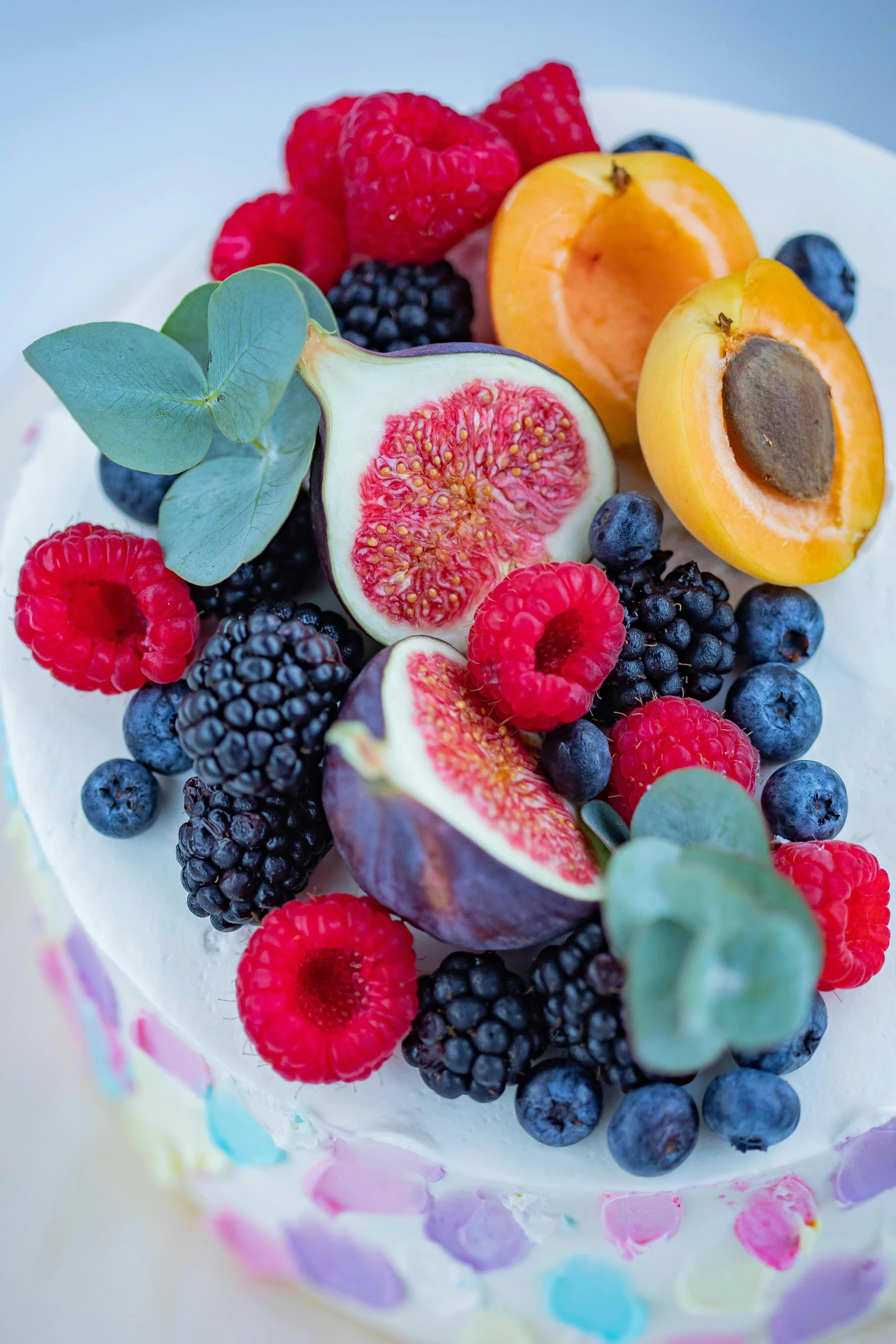 a close up of a cake with fruit and vegetables