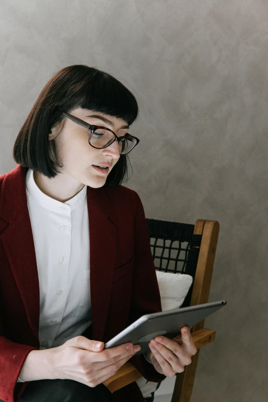 a woman sitting in a chair looking at soing