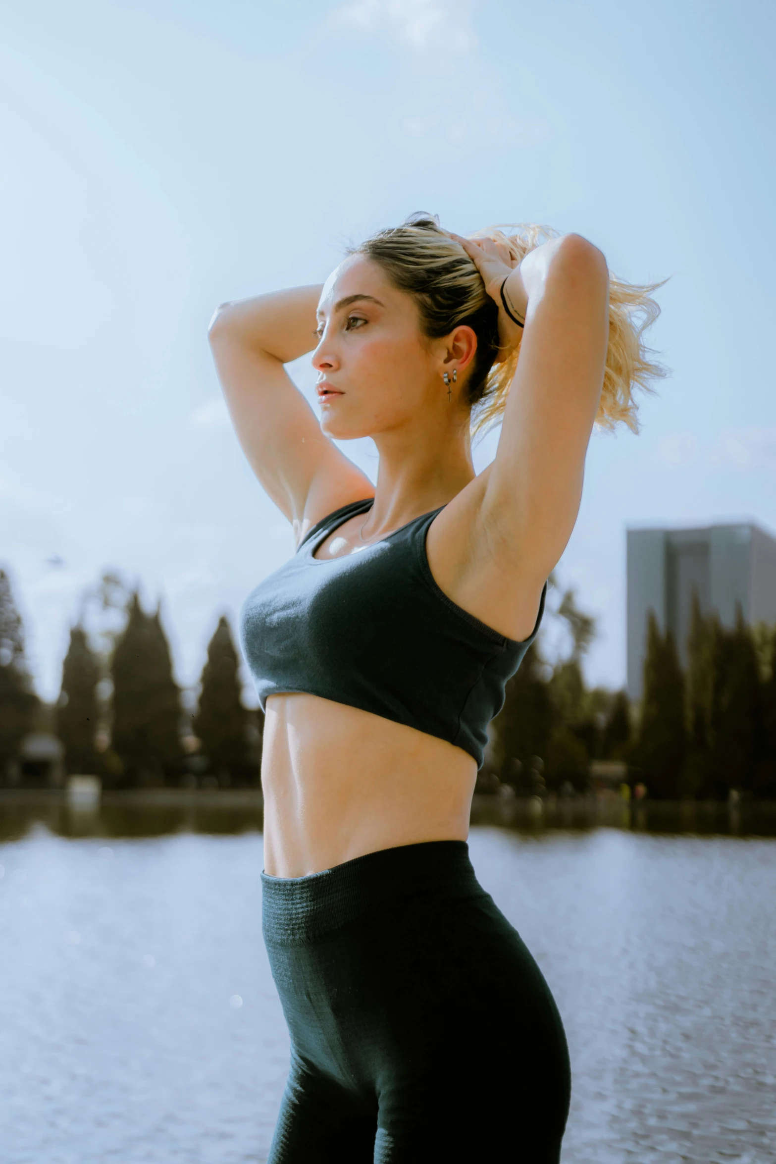 a young woman stands near a body of water