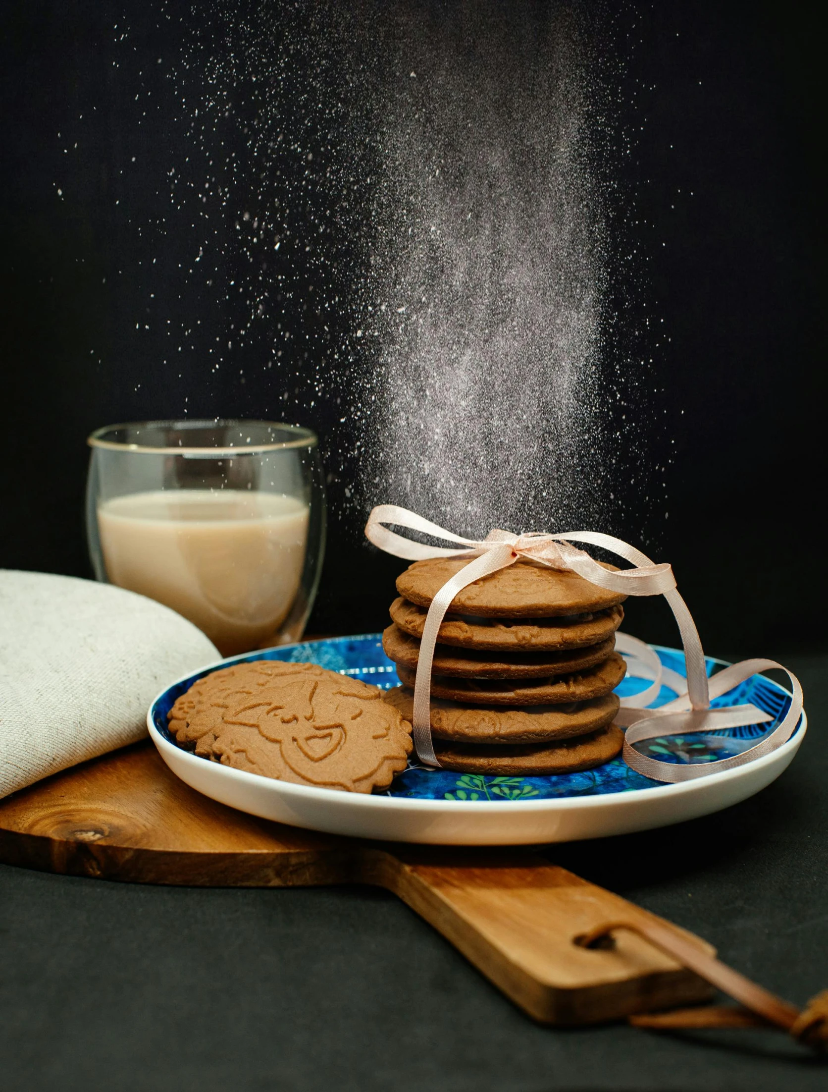 a plate with cookies on it and salt being thrown into the air