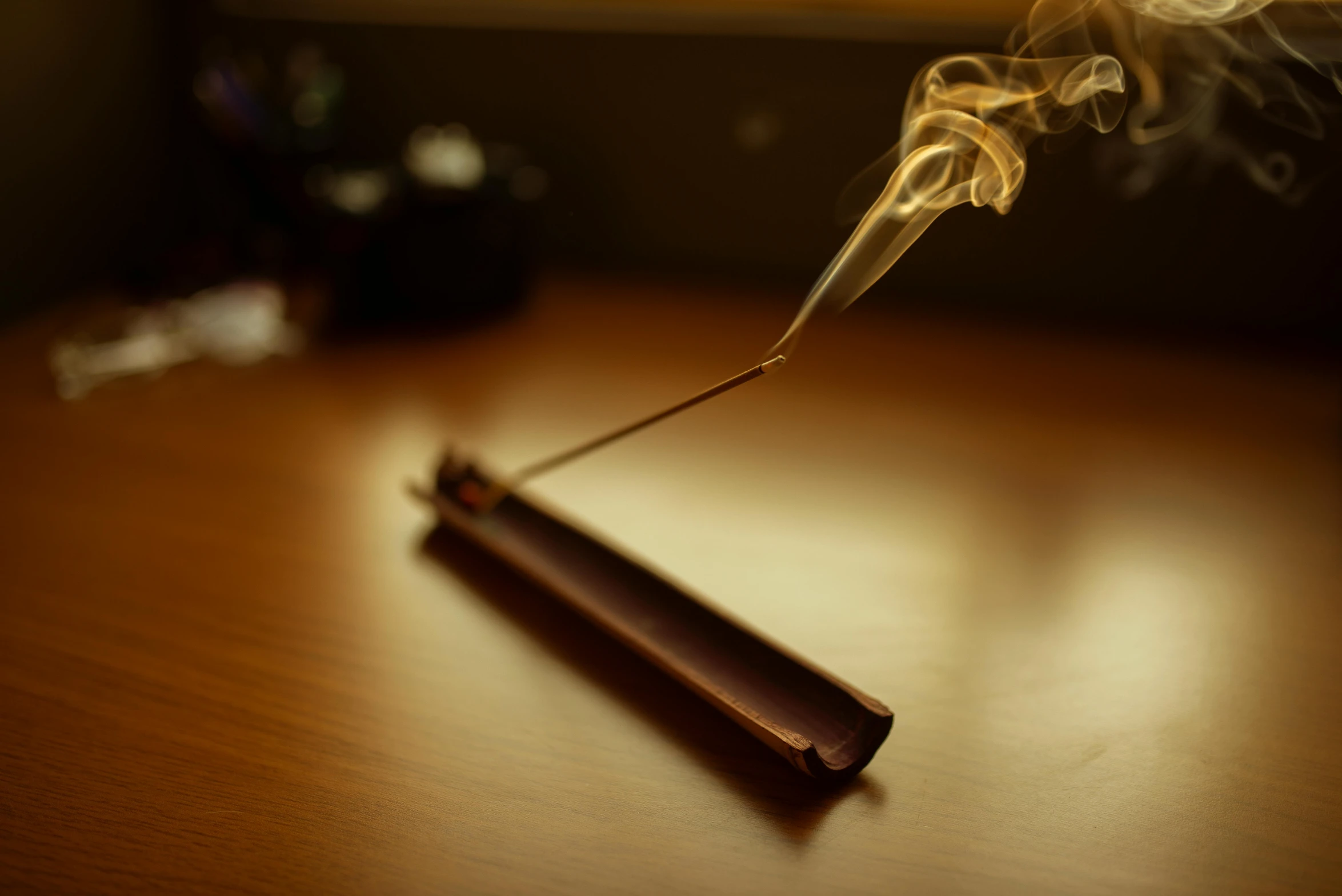 smoke and some sort of an object on a wooden table