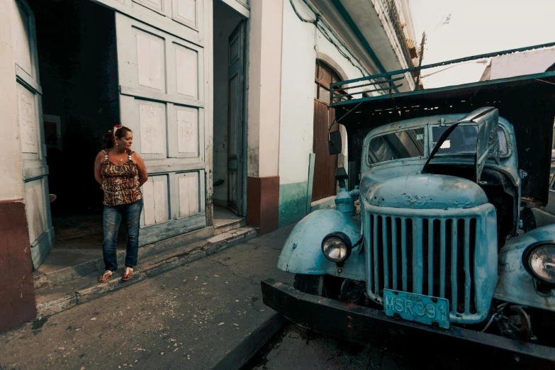 an older truck parked on the side of the road