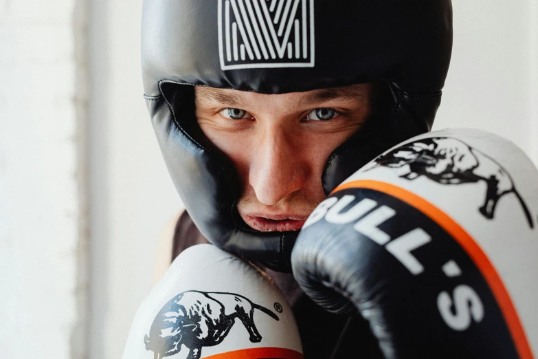 a man standing by two boxing gloves with an arm wrapped around them