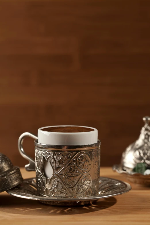 a silver plate and cup with a white top