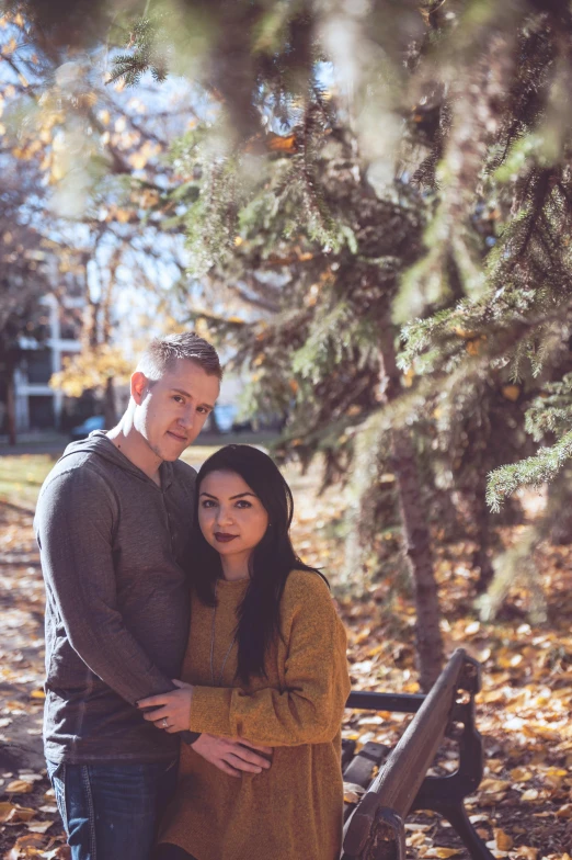 a man and a woman standing next to each other on a bench