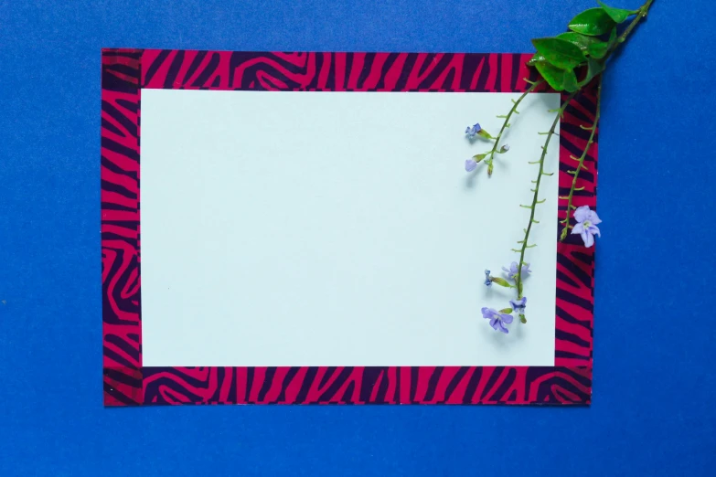 an empty piece of paper with flowers and a piece of paper behind it