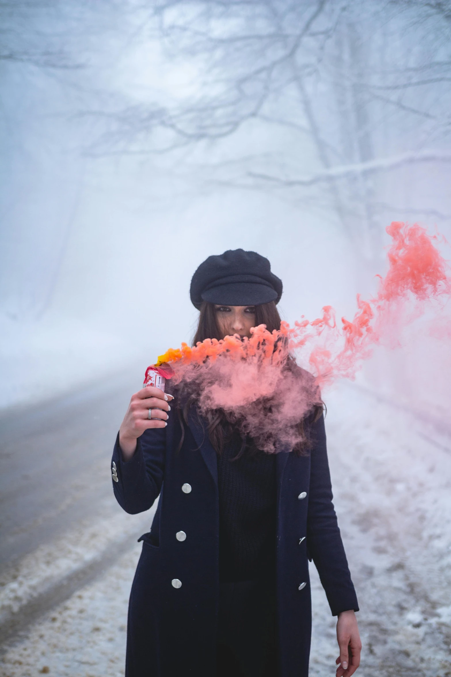 a girl is standing with a cigarette and her hand up to her mouth