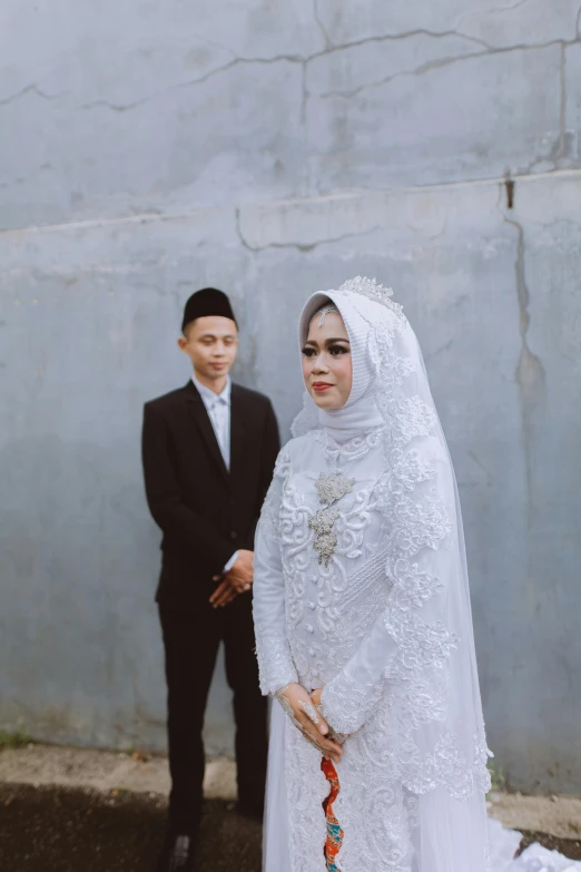 a bride and groom in front of a building