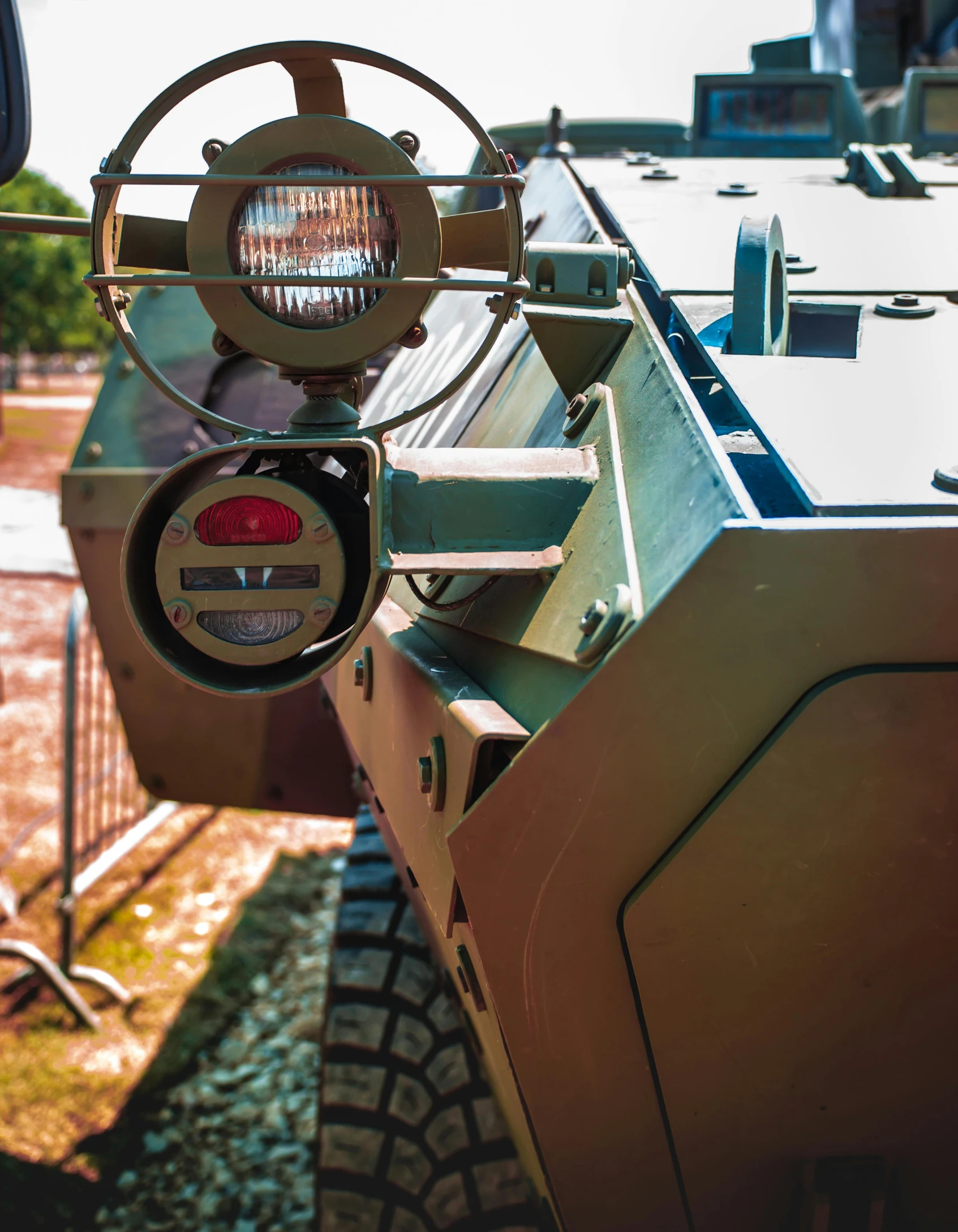 a green military vehicle with a large light on top