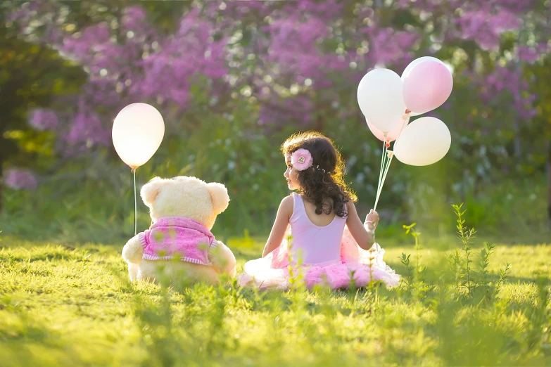 a  with several balloons sitting down