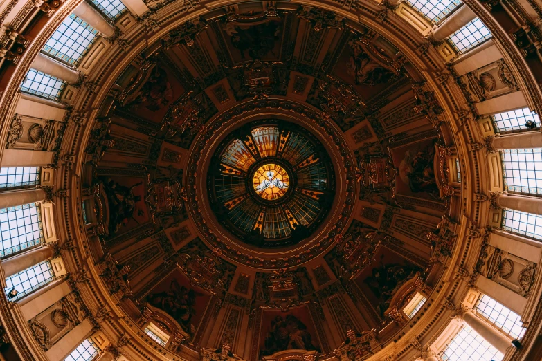 the ceiling in a church with many stained glass windows