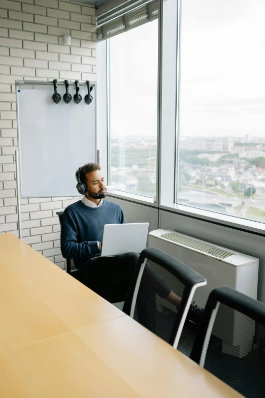 a person using a laptop in a conference room