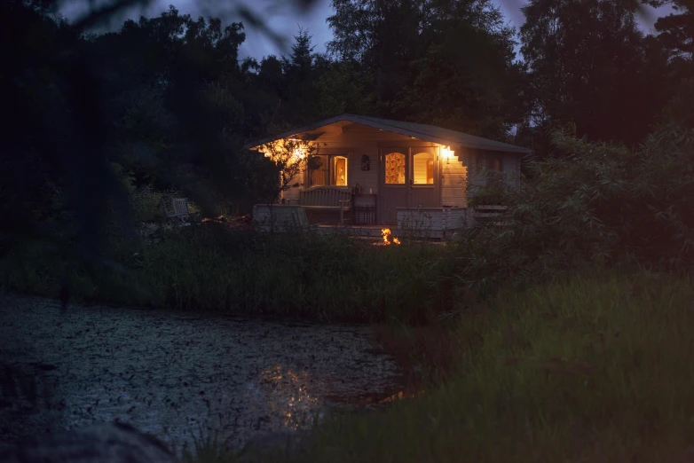 a house with a porch is lit by the bright lights of a street light