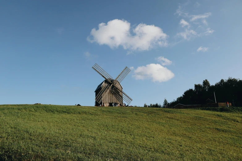 an old windmill on top of a hill