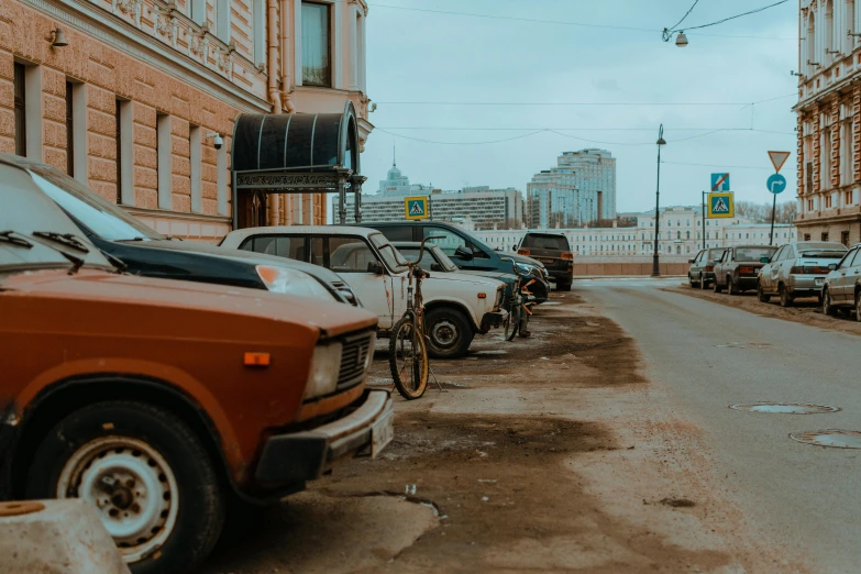 old cars lined up next to one another on the side of a road