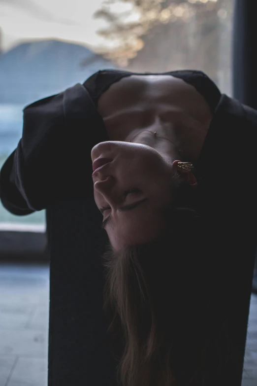 a woman with long hair is laying on a chair