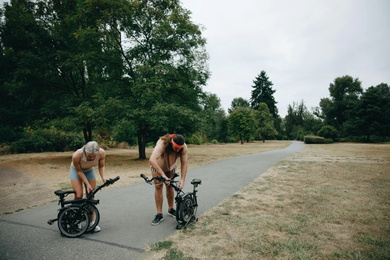 two women riding their bikes down a road