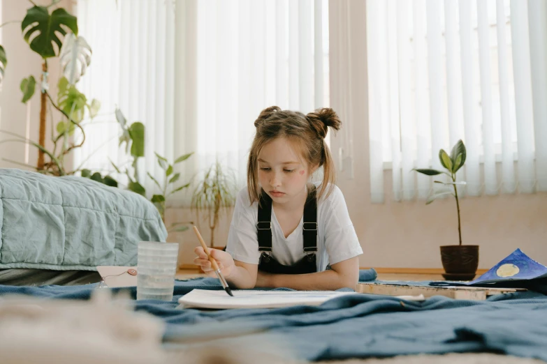 a  sitting at a table with a pen and paper