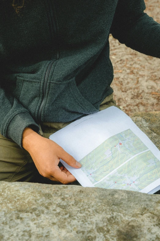 a person sitting and looking at a map