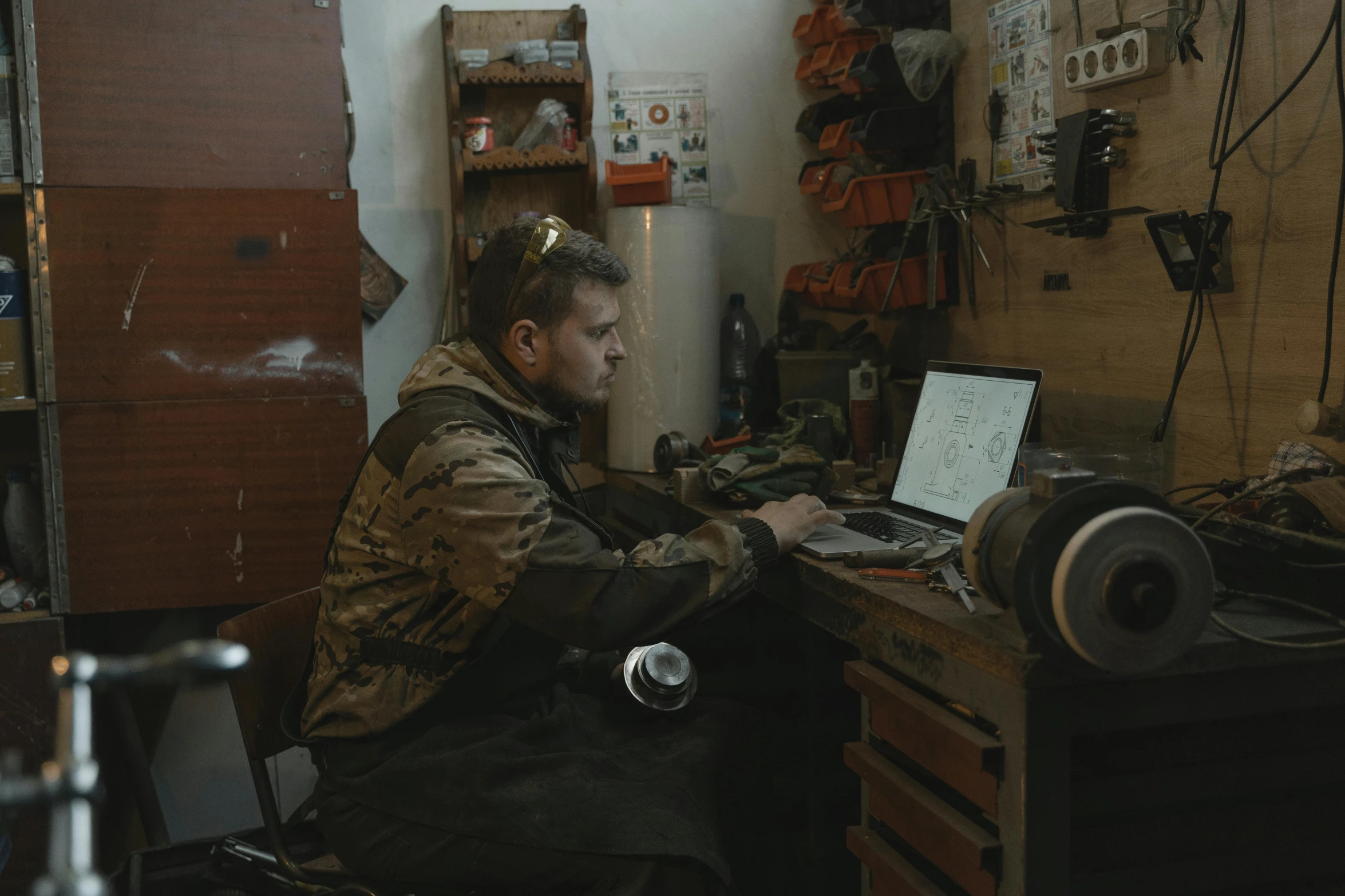 a man sitting in a room using his laptop