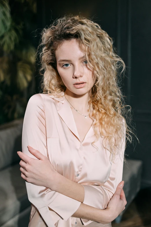 a woman with curly hair is posing for a po