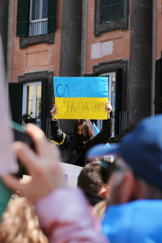 a woman holds a sign that says peace, climate change