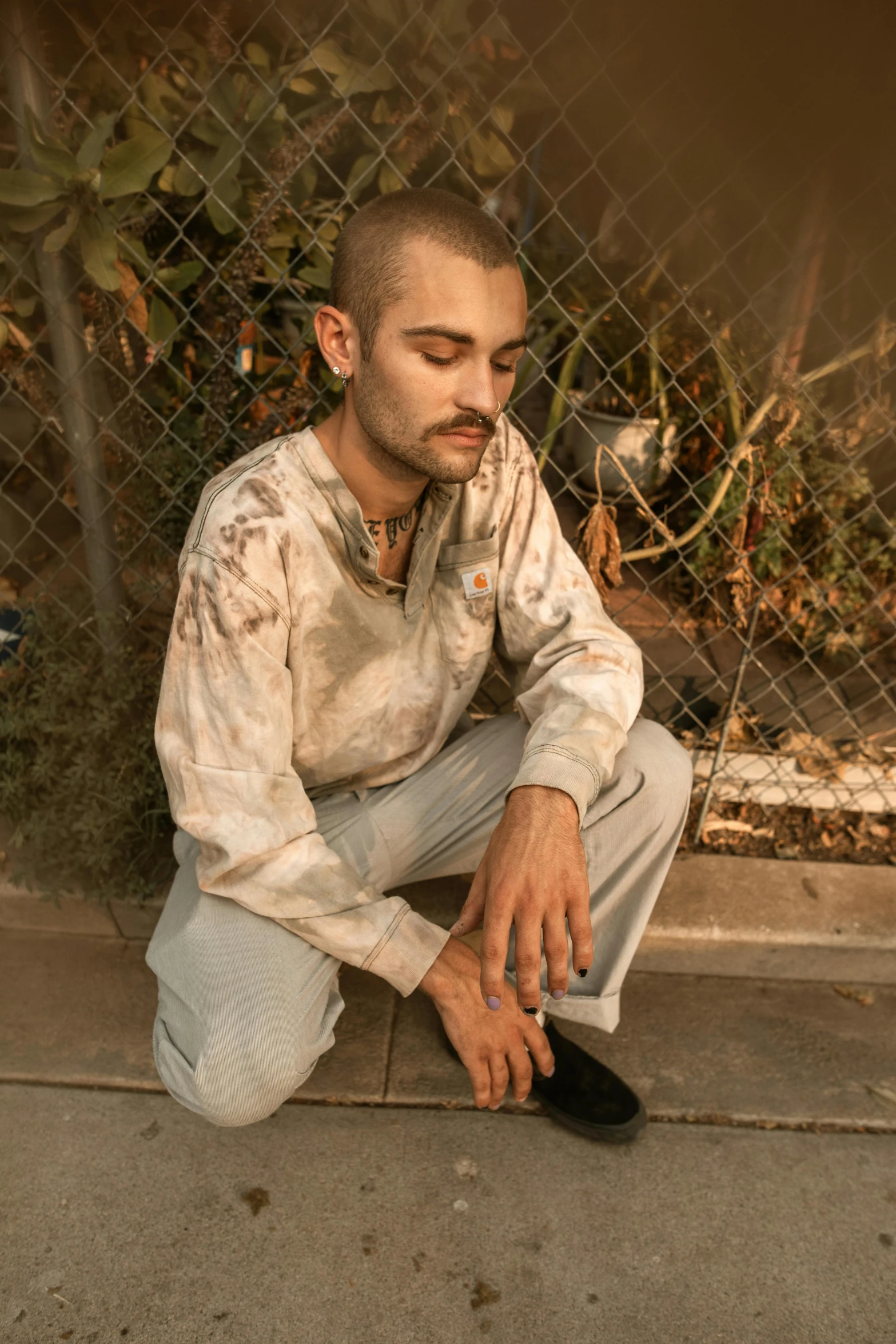 a man in a tie is sitting on the sidewalk