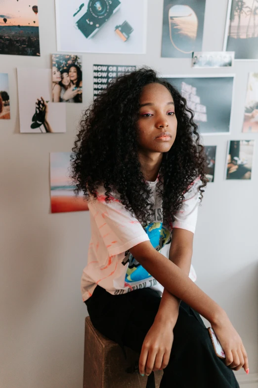 young woman sitting on counter at home looking up