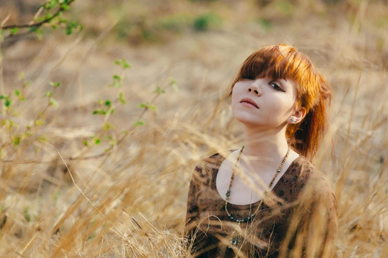 a young woman is in a field with tall grass