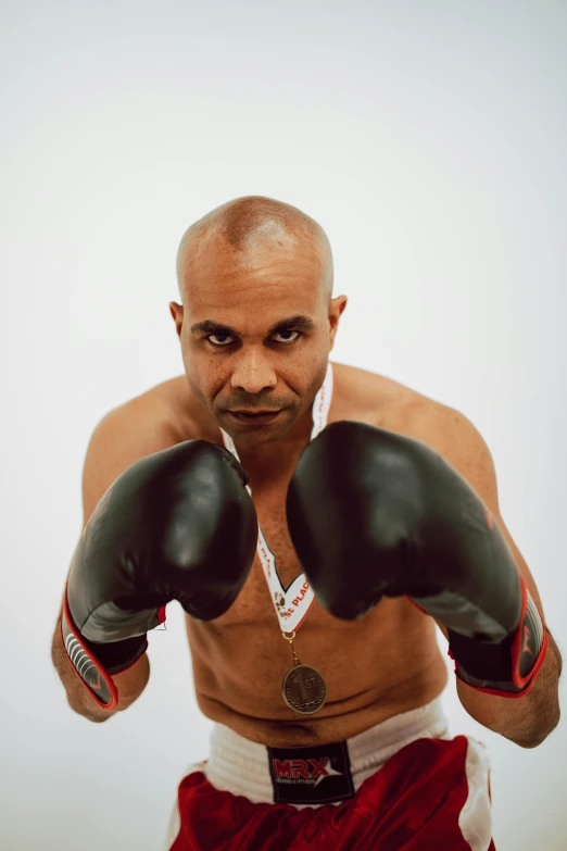 a man in boxing gear is posing for the camera