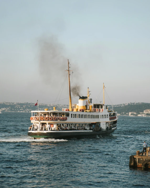 a large boat sailing in a lake with steam coming from it