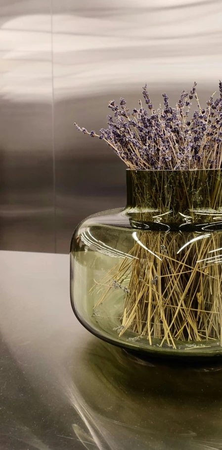 the lavender sprigs are in a vase on a table