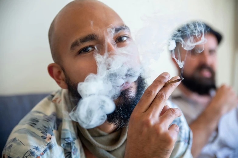 a man smoking and looking at the mirror