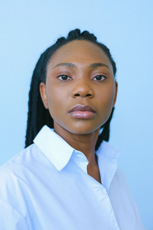 an african american woman wearing a white shirt with ids