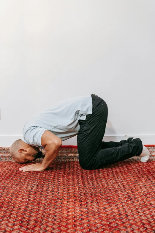 a man on his stomach is standing on a rug