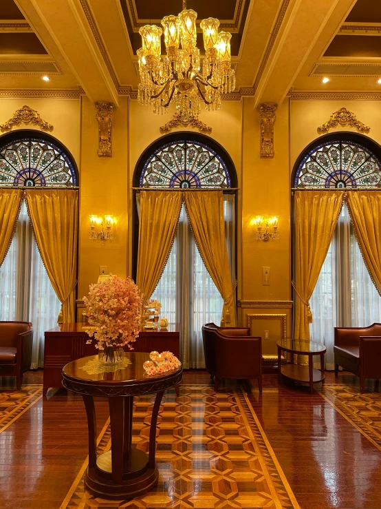 a fancy lobby with chandelier and stained glass windows