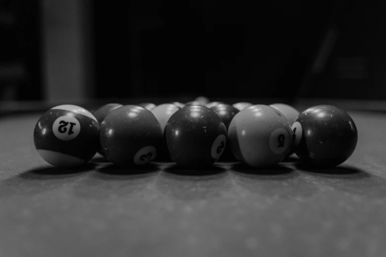 six pool balls lined up together in the shape of numbers