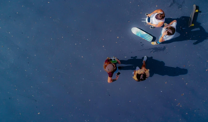 three people are riding their skateboards on the road