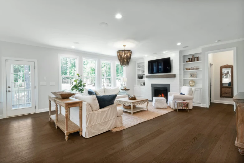 a living room with large windows and wood floors